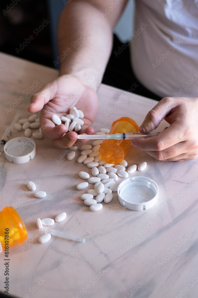 Sadness and addicted person with many drugs and vacum front her on the table Sadness and addicted person with many drugs and vacum front her on the table