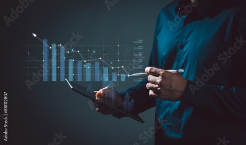Businessman holds a tablet with augmented reality holographic statistics. Graphs and Targets Developing a growing business strategy and growth plan Investing in Currency Rate Growth