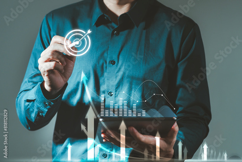 Businessman holds a tablet with augmented reality holographic statistics. Graphs and Targets Developing a growing business strategy and growth plan Investing in Currency Rate Growth