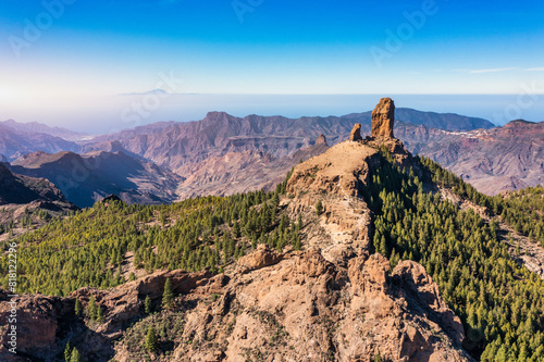 Roque Nublo and Pico de Teide in the background on Gran Canaria Island, Spain. Panoramic view of Roque Nublo sacred mountain, Roque Nublo Rural Park, Gran Canary, Canary Islands, Spain.