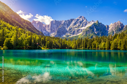 Fototapeta Naklejka Na Ścianę i Meble -  Picturesque lake Lago Fusine in Italy. Fusine lake with Mangart peak on background. Popular travel destination of Julian Alps. Location: Tarvisio comune , Province of Udine, Italy, Europe.