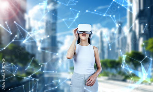 Female standing and wearing white VR headset and white sleeveless connect metaverse, future technology creating cyberspace community. She enjoy looking around fantasy building in meta. Hallucination.