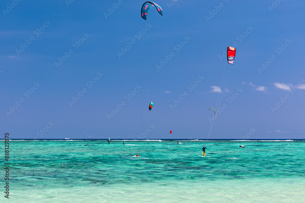 Kite surfers in the waters of Indian Ocean, Mauritius. Kite surfing in the clear waters of the Indian Ocean in Le Morne beach, Mauritius. Best Kite surfing experience at Mauritius island. Kite surfers in the waters of Indian Ocean, Mauritius. Kite surfing in the clear waters of the Indian Ocean in Le Morne beach, Mauritius. Best Kite surfing experience at Mauritius island.