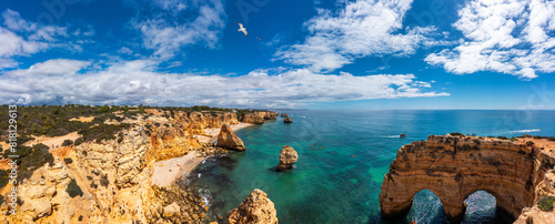 Praia da Marinha, beautiful beach Marinha in Algarve, Portugal. Navy Beach (Praia da Marinha) with flying seagulls over the beach, located on the Atlantic coast in Lagoa Municipality, Algarve.