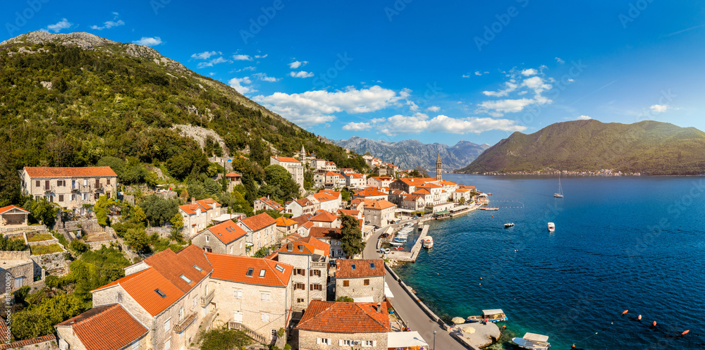 Naklejka premium View of the historic town of Perast at famous Bay of Kotor on a beautiful sunny day with blue sky and clouds in summer, Montenegro. Historic city of Perast at Bay of Kotor in summer, Montenegro.