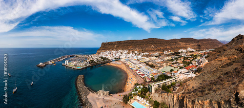 Puerto de Mogan with the beach in Gran Canaria, Spain. Favorite vacation place for tourists and locals on island. Harbor in Puerto de Mogan and Playa Mogan on Grand Canary Island, Spain. photo