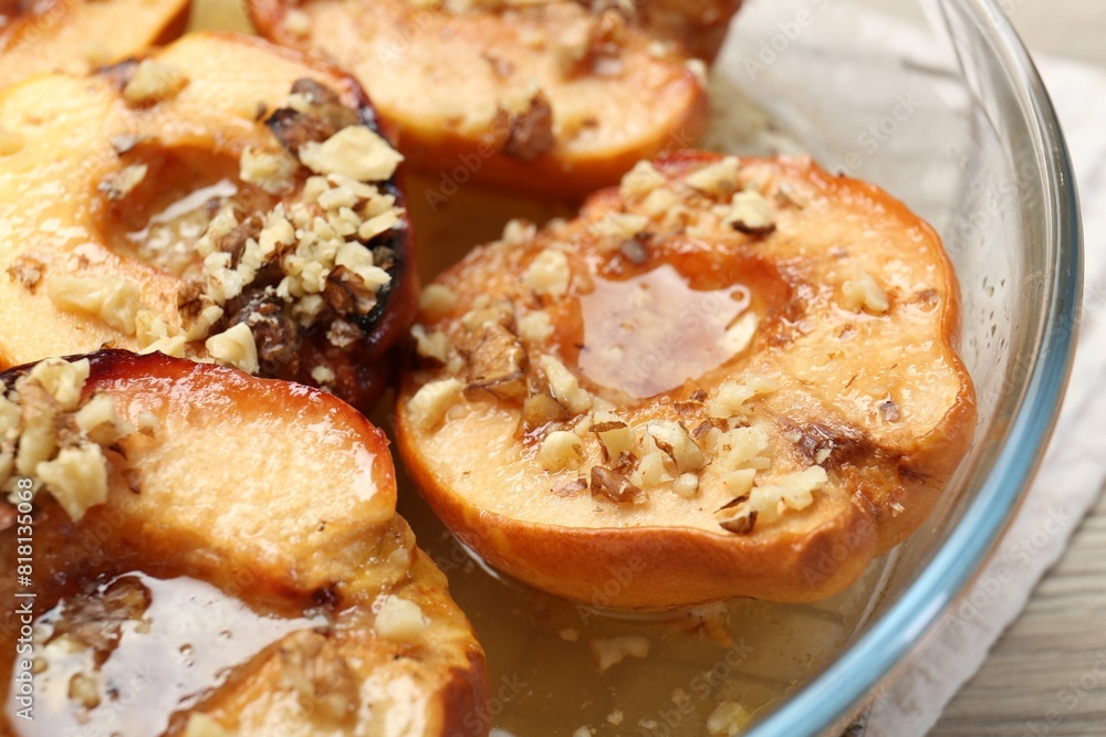 Delicious baked quinces with nuts and honey in bowl, closeup Delicious baked quinces with nuts and honey in bowl, closeup