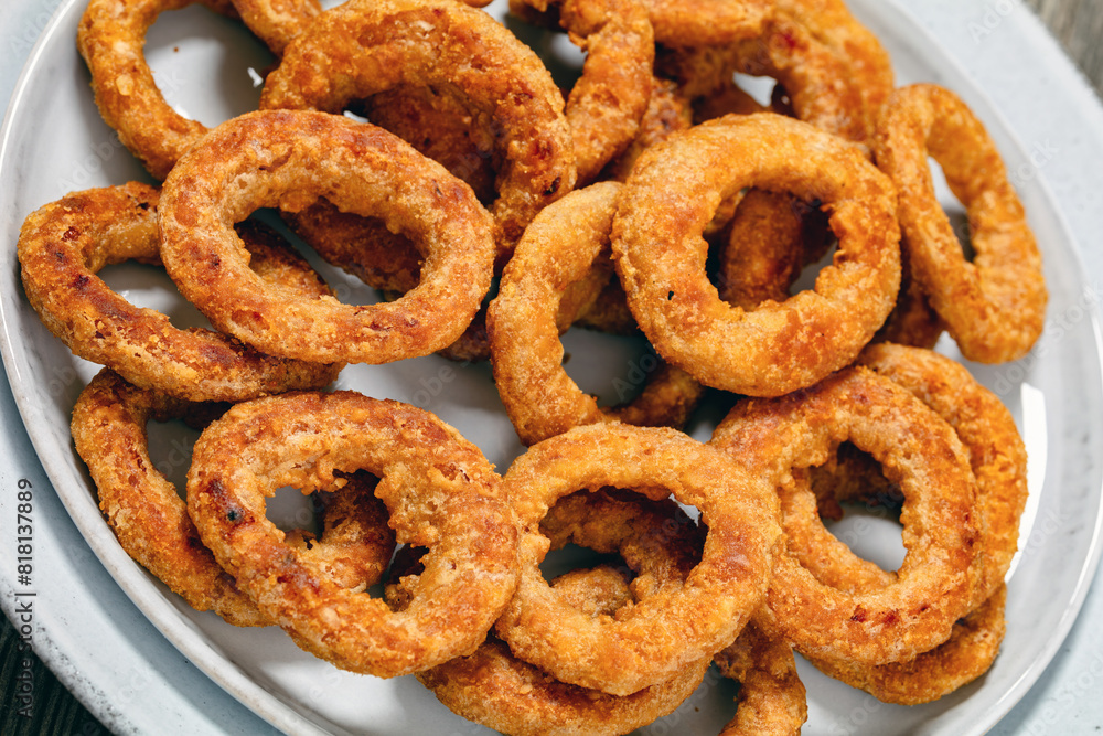 deep fried crispy onion rings on grey plate deep fried crispy onion rings on grey plate