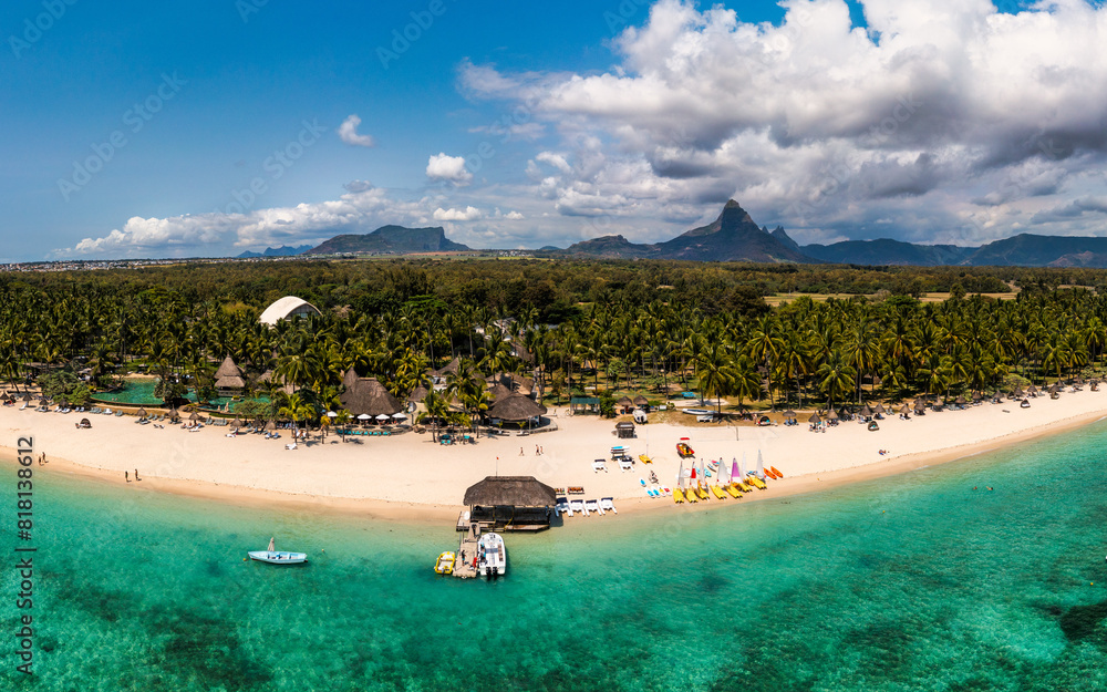 Fototapeta premium Beautiful Mauritius Island with gorgeous beach Flic en Flac, aerial view from drone. Mauritius, Black River, Flic-en-Flac view of oceanside village beach and luxurious hotel in summer.