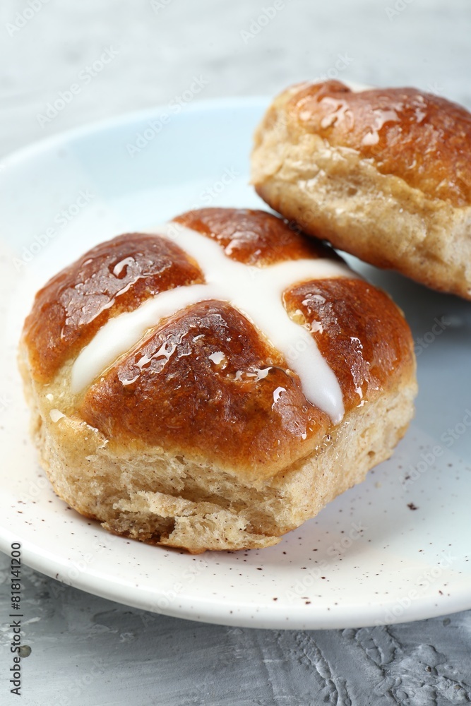 Tasty hot cross buns on gray textured table, closeup Tasty hot cross buns on gray textured table, closeup