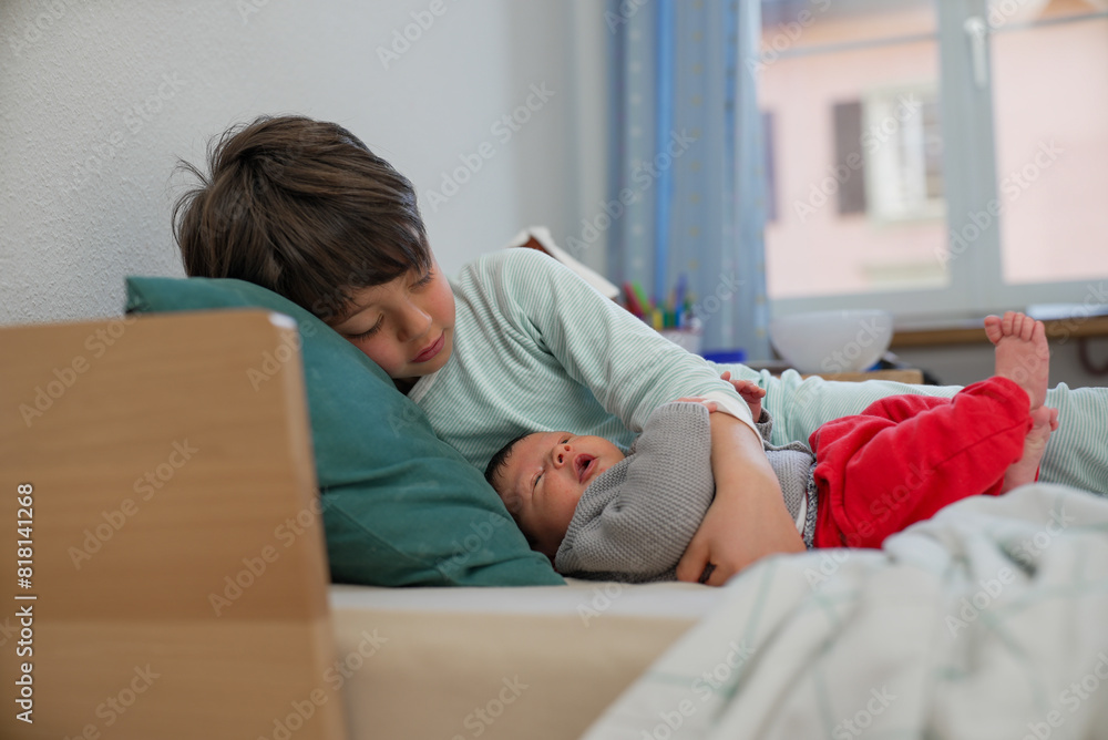 Older sibling lying down with newborn baby, both resting peacefully. The room’s soft lighting and cozy atmosphere emphasize the loving and serene sibling bond Older sibling lying down with newborn baby, both resting peacefully. The room’s soft lighting and cozy atmosphere emphasize the loving and serene sibling bond