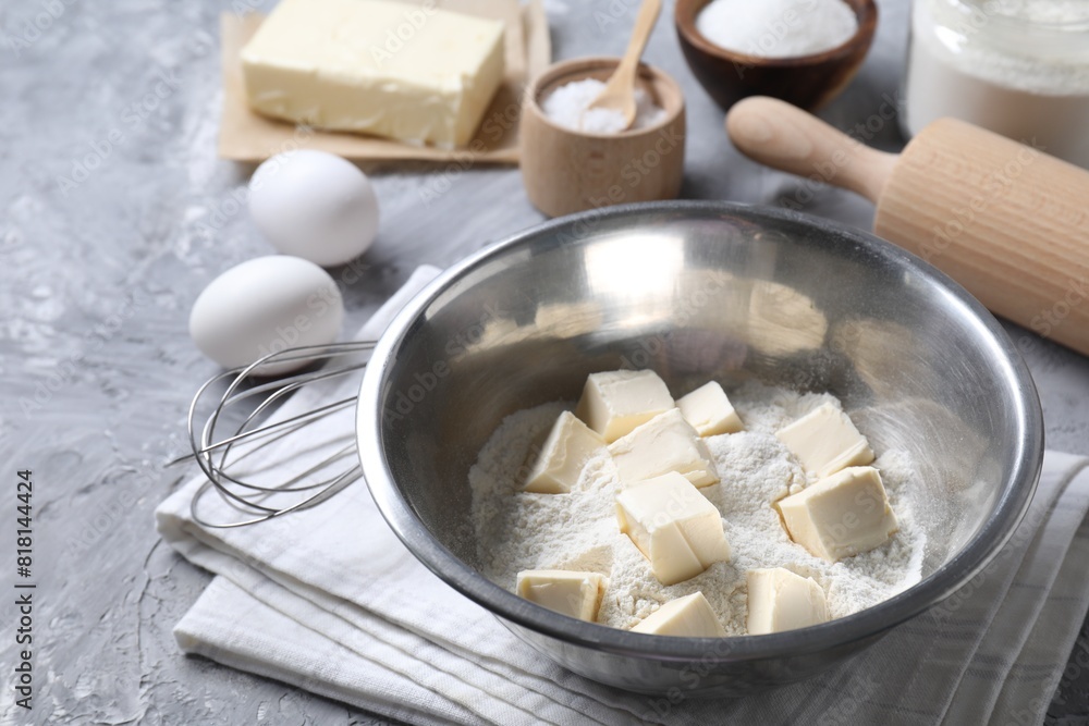 Making shortcrust pastry. Different ingredients for dough, whisk and rolling pin on grey table Making shortcrust pastry. Different ingredients for dough, whisk and rolling pin on grey table