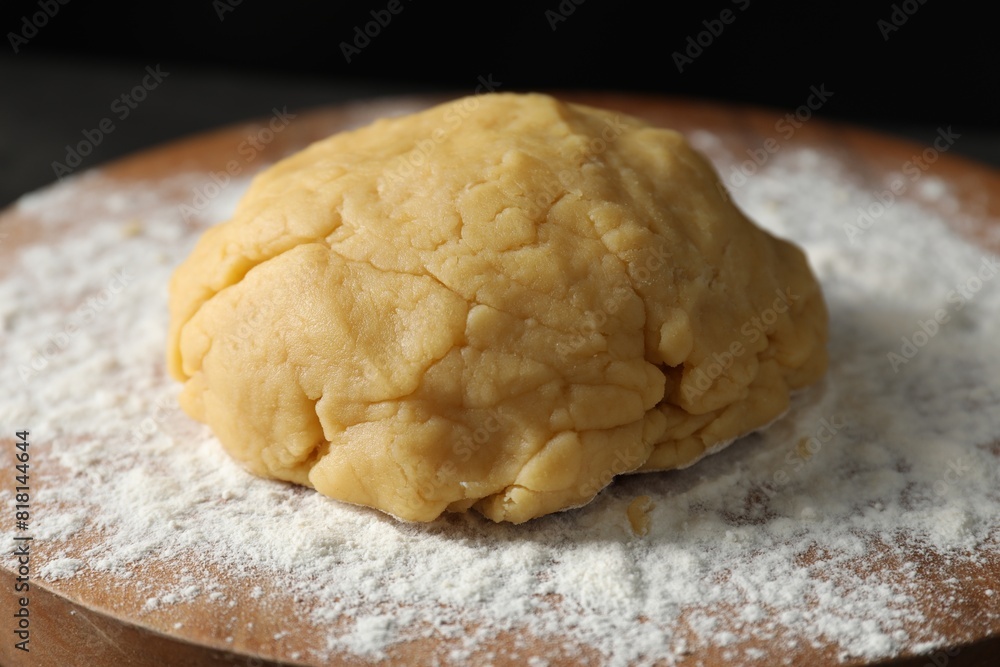 Making shortcrust pastry. Raw dough and flour on board, closeup