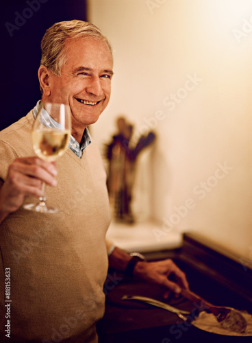 Happy, senior man, and wine glass in home for cooking, retirement and nutrition for wellness. Male person, chef and alcohol with vegetables for salad, prepare food and vegan diet with pride