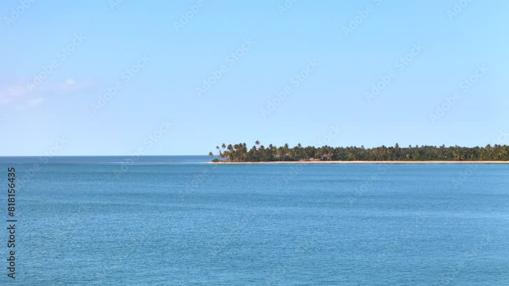 Aerial drone flight above calm blue sea water with palm tree grove on the coast of beautiful wild tropical beach at sunset. 4k paradise island footage Aerial drone flight above calm blue sea water with palm tree grove on the coast of beautiful wild tropical beach at sunset. 4k paradise island footage