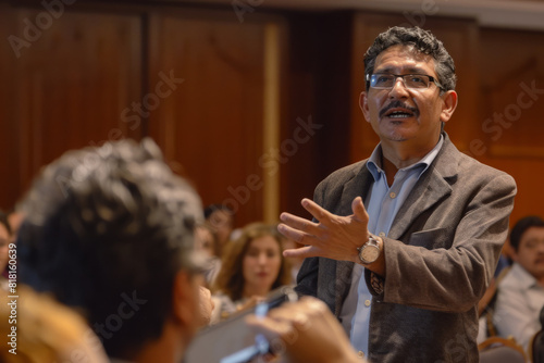 A Latino CEO, addressing shareholders at a corporate AGM, articulating his strategic vision for the company's growth with passion and conviction, his magnetic personality captivating the audience. photo