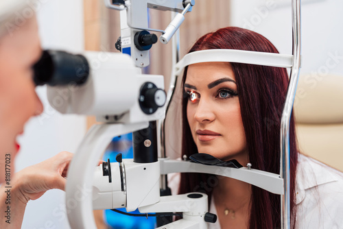 Beautiful female doctor ophthalmologist is checking the eye vision of senior woman in a modern clinic. Doctor and patient during medical check up in ophthalmology clinic.