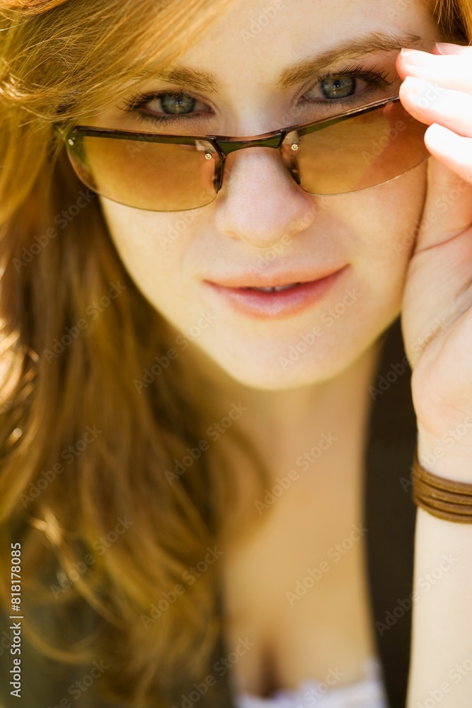 Woman Looking Over Sunglasses Woman Looking Over Sunglasses