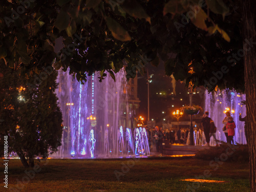 Blurry view over people walking and having rest around the fountains at Maidan Nezalezhnosti square in Kyiv (Kiev) city, Ukraine. Urban lifestyle.