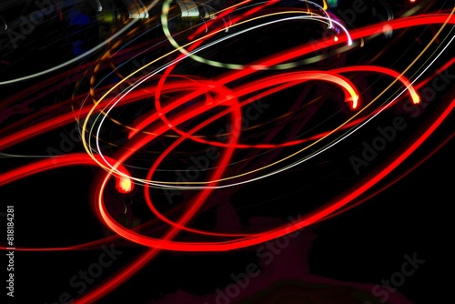 A series of red and yellow lines are shown in a black background. The lines are moving and overlapping, creating a sense of motion and energy. The image conveys a feeling of excitement and movement