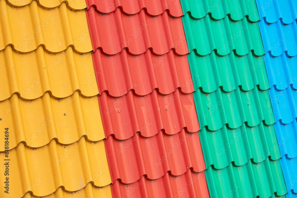 A row of colorful roofs with a rainbow of colors A row of colorful roofs with a rainbow of colors