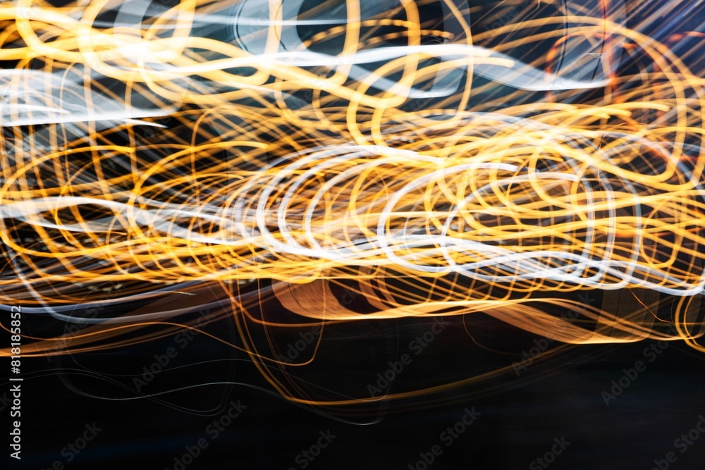 a blurry, wavy line of light that appears to be yellow and white. The lines are moving and seem to be coming from a point in the distance. Scene is dynamic and energetic a blurry, wavy line of light that appears to be yellow and white. The lines are moving and seem to be coming from a point in the distance. Scene is dynamic and energetic