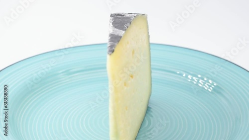 slice of Italian cheese Bastard of Grappa,Bastardo del Grappa,fetta di formaggio Asiago,macro close-up,rotating video photo