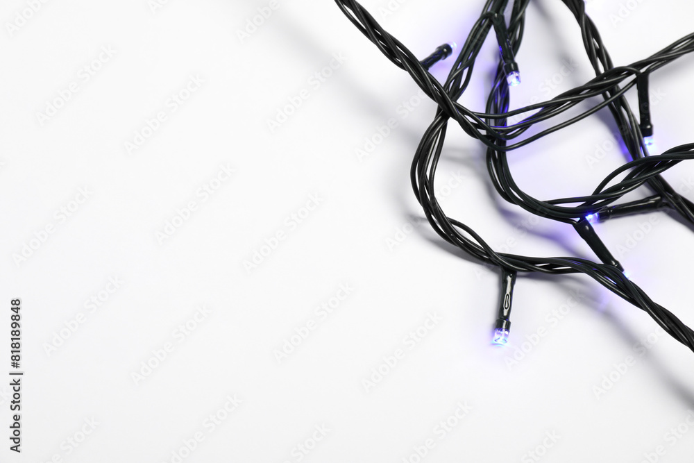 Beautiful Christmas lights on white background, top view Beautiful Christmas lights on white background, top view