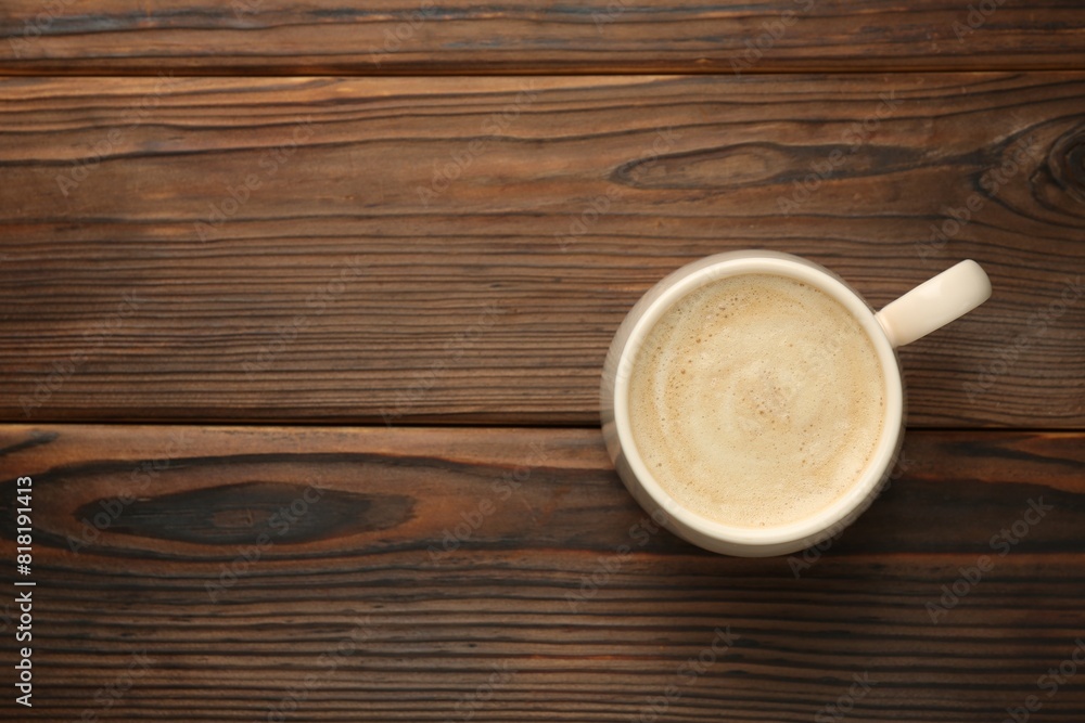 Cup of coffee on wooden table, top view. Space for text Cup of coffee on wooden table, top view. Space for text