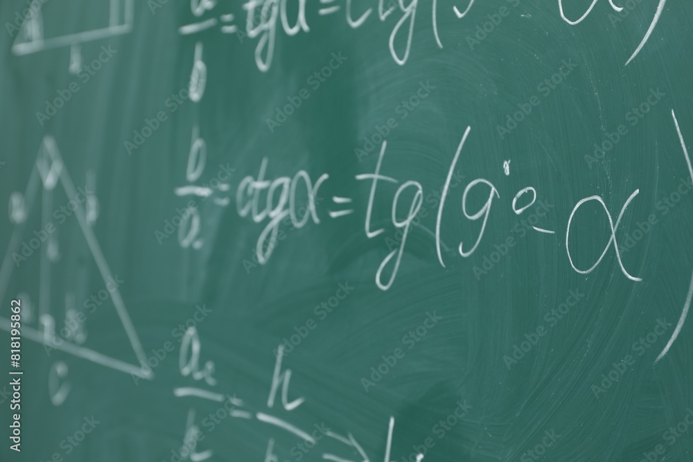 Many different math formulas written on chalkboard Many different math formulas written on chalkboard