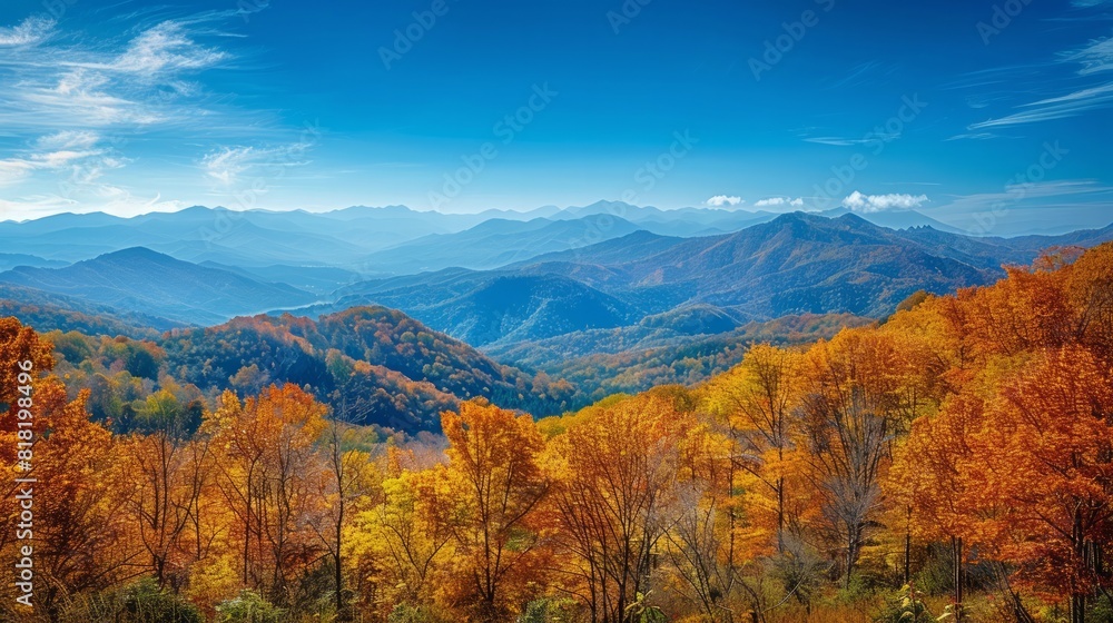 A majestic mountain range in autumn, with colorful foliage, clear blue skies, and a peaceful valley below, showcasing the beauty of nature in the fall season