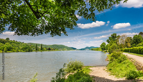 Unkel, Rheinland-Pfalz, Germany: Panoramic View of the Rhine Rhein River Promenade with Trees, Greenery and Blue Sky