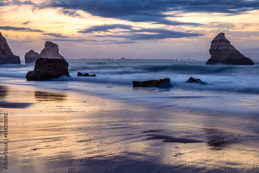 Sunrise at Praia Dona Ana beach, with its spectacular sea stacks and cliffs in Lagos, Algarve, Portugal. Sunrise at Praia Dona Ana beach, with its spectacular sea stacks and cliffs in Lagos, Algarve, Portugal.