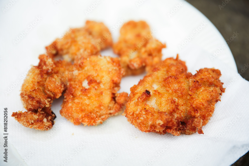 golden, crispy fried chicken pieces in bubbling oil, symbolizing indulgence and temptation golden, crispy fried chicken pieces in bubbling oil, symbolizing indulgence and temptation