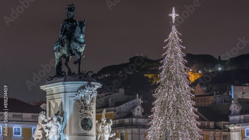 Commerce square illuminated and decorated at Christmas time in Lisbon night timelapse. Commercio square with Christmas tree and Jose I monument. People tourists crowd around. Holiday times. Portugal