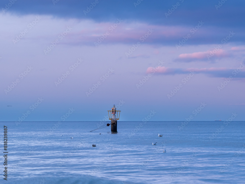Sea buoy on the background of the sunset on the Baltic coast