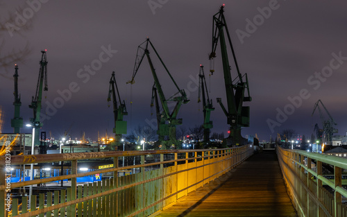 Obraz na płótnie Cranes of the Gdańsk Shipyard on the Baltic coast at night w salonie