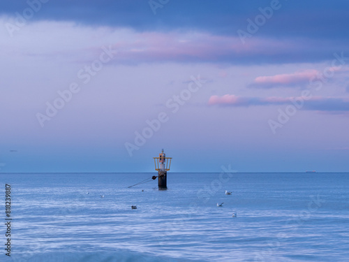 Obraz na płótnie Sea buoy on the background of the sunset on the Baltic coast w salonie
