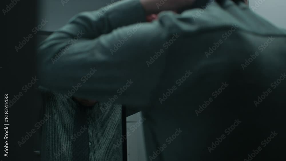 A tired middle-aged man in a grey shirt during his morning routine A tired middle-aged man in a grey shirt during his morning routine