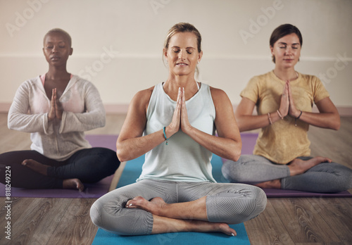 Yoga, prayer hands and group of people for meditation, breath work and class in wellness studio. Zen, peace and holistic training for mental health, female coach and exercise for spiritual energy