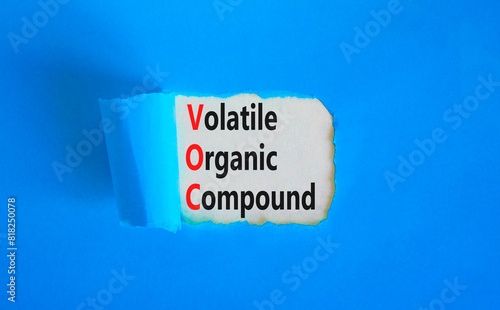 VOC volatile organic compound symbol. Concept words VOC volatile organic compound on beautiful white paper. Beautiful blue background. Business VOC volatile organic compound concept. Copy space.