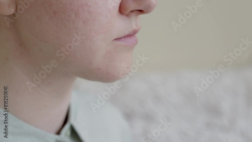 double chin in a caucasian woman. Woman pinching fat on chin and looking at mirror close up