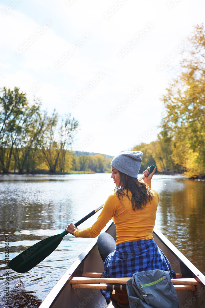 Woman, back and canoe in forest on water, wellness hobby and backpack for supplies with paddle for rowing. Vacation, relax and explore exercise on travel holiday, canoeing boat and trees on river Woman, back and canoe in forest on water, wellness hobby and backpack for supplies with paddle for rowing. Vacation, relax and explore exercise on travel holiday, canoeing boat and trees on river