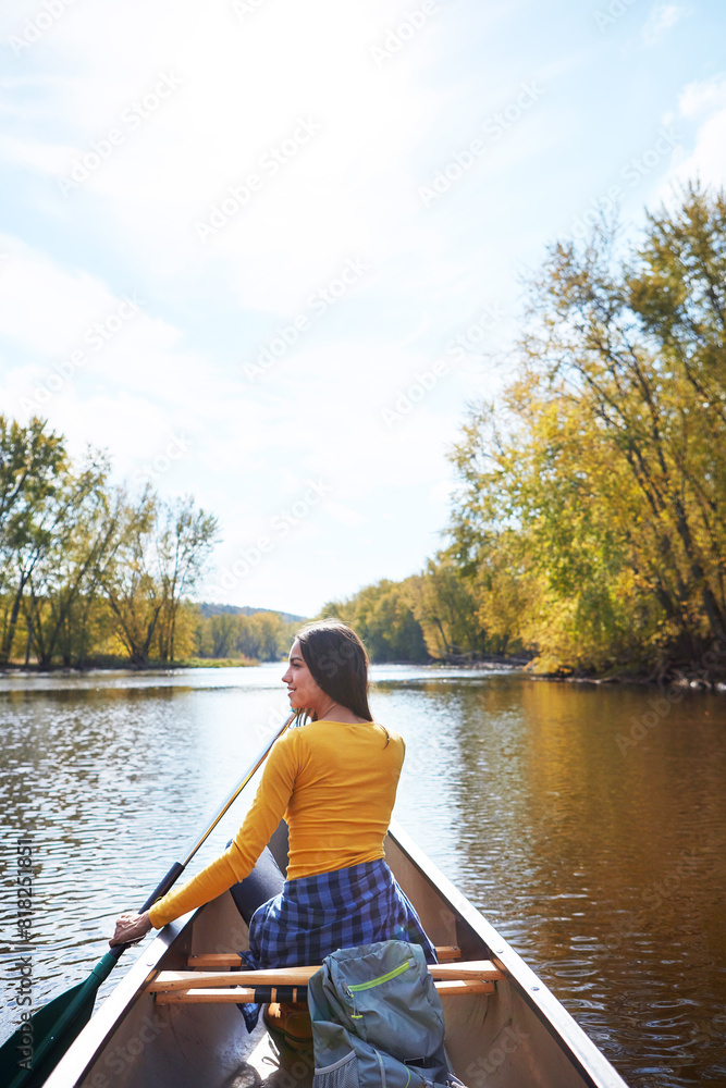 Woman, back and canoeing paddle in nature on lake, wellness hobby and backpack for supplies and rowing for water sport. Vacation, relax and explore exercise on travel holiday, canoe boat and trees Woman, back and canoeing paddle in nature on lake, wellness hobby and backpack for supplies and rowing for water sport. Vacation, relax and explore exercise on travel holiday, canoe boat and trees