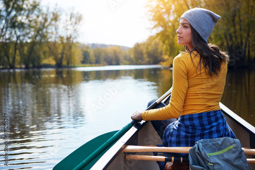 Woman  back and canoeing for water sport in nature  wellness hobby and single blade paddle for rowing. Vacation  relax and explore exercise on travel for summer holiday  canoe boat and trees on river