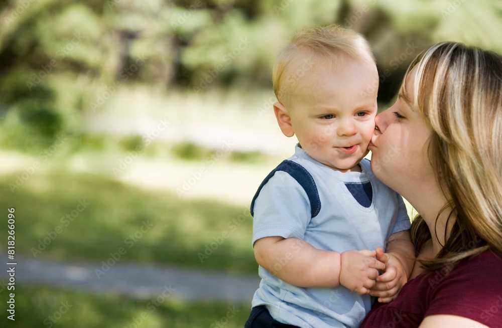 Fototapeta premium A Mother Kissing A Boy