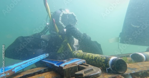 Commercial diver works on underwater pipeline