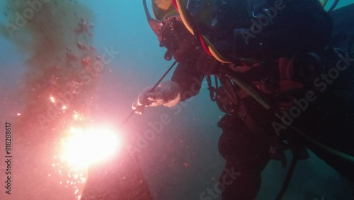 Commercial diver cutting steel underwater closeup
