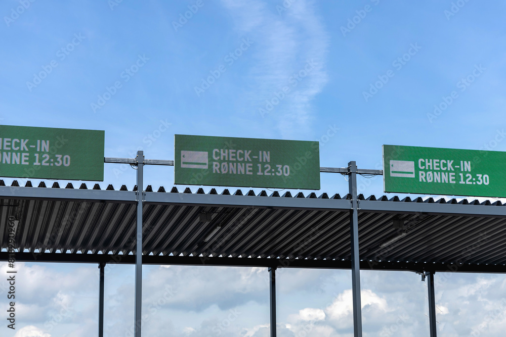 Seaport and terminal for passenger ferry transport in the city of Ystad. Gate for the ferry to Ronne, Bornholm with the inscription on the information board check in - Ronne. Ystad, Sweden - May 14