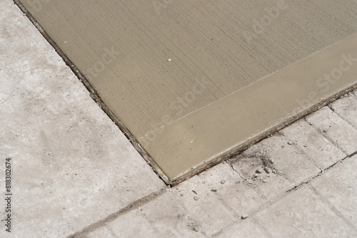 Fotografi freshly poured section of concrete drying on sidewalk